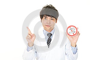 Doctor holds non smoking sign