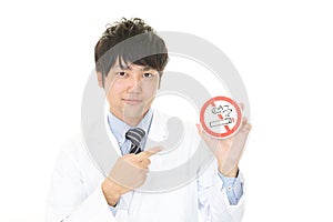 Doctor holds non smoking sign