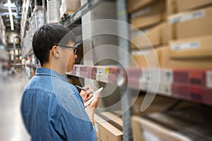 Portrait Asian men, staff, product counting Warehouse Control Manager Standing, counting and inspecting products in the warehouse