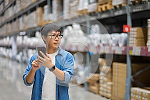 Portrait Asian men, staff, product counting Warehouse Control Manager Standing, counting and inspecting products in the warehouse