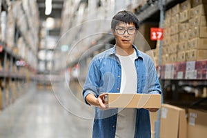 Portrait Asian men, staff, product counting Warehouse Control Manager Standing, counting and inspecting products in the warehouse