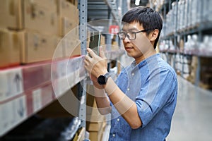 Portrait Asian men, staff, product counting Warehouse Control Manager Standing, counting and inspecting products in the warehouse