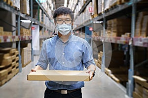 Portrait Asian men, staff, product counting Warehouse Control Manager Standing, counting and inspecting products in the warehouse