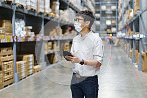 Portrait Asian men, staff, product counting Warehouse Control Manager Standing, counting and inspecting products in the warehouse