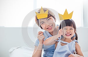 Portrait of asian mother and child daughter playing having fun together.