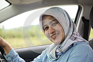 Muslim Lady Driving Her Car and Smiling photo