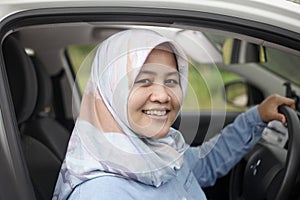 Muslim Lady Driving Her Car and Smiling photo