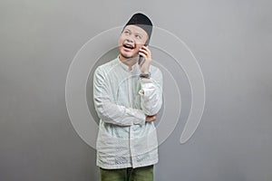 Portrait of an Asian Muslim man calling with family or friend