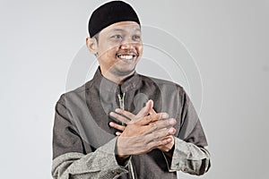 Portrait of an Asian Muslim man smiling and wanting to shake his interlocutor\'s hand