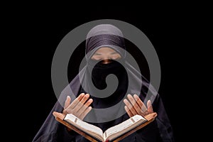 Portrait Asian Muslim woman standing and reading the Quran and appreciates and faith