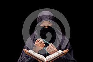 Portrait Asian Muslim woman standing and reading the Quran and appreciates and faith