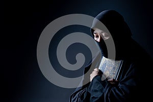 Portrait Asian Muslim woman standing and reading the Quran and appreciates and faith