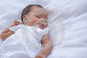 Portrait of asian newborn baby sleeping peacefully on the furry bed