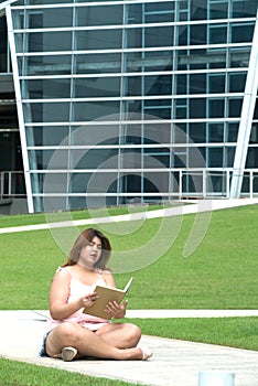 Portrait of Asian pretty smiley face fat woman pose ,holding and reading a book.