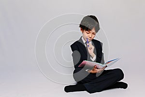 Portrait of an Asian schoolboy reading his texbook