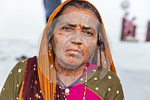 Portrait of Asian senior beautiful woman serious sad wearing traditional Indian dress sari.