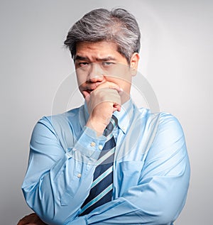 Portrait of Asian senior businessman in suit is thinking on white background isolated background. The Concept of management and