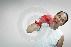 Portrait of Asian senior man punching his face