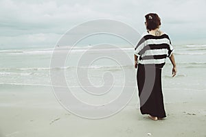Portrait asian single tattoo hipster indy women lonely stand alone on the beach