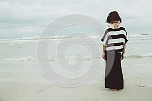 Portrait asian single tattoo hipster indy women lonely stand alone on the beach