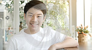 Portrait of asian smiling teen boy. Medium shot of handsome guy