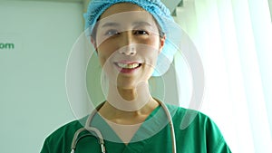 Portrait of Asian surgeon holding tablet and standing in front of operation theater at a hospital. Team of Professional surgeons.