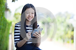 Portrait of asian teen and computer tablet in hand use for digit