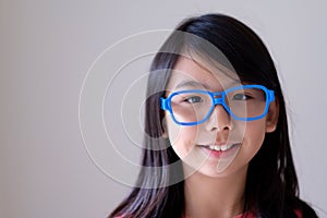 Portrait of Asian teenager with big blue glasses