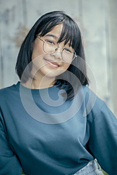 portrait of asian teenager smiling with happiness wearing casual clothes