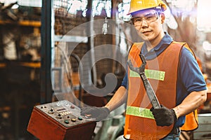 Portrait of Asian Thai Chinese labor happy worker enjoy happy smiling to work in a heavy industrial factory to fix machine with