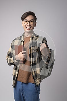 Portrait of an Asian university student over white background studio, education concept