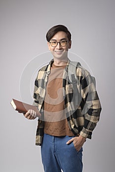 Portrait of an Asian university student over white background studio, education concept