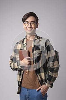 Portrait of an Asian university student over white background studio, education concept