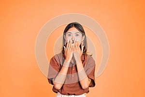 portrait of asian woman covering her mouth with hands