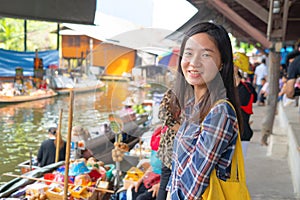 Portrait of Asian woman at Damnoen Saduak Floating Market in Ratchaburi District in travel trip and holidays vacation concept,