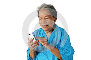 Portrait of an Asian woman with gray hair, wearing a Chinese blue shirt using a mobile phone with a smile that is isolated