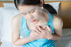 Portrait of Asian woman having chest pain or heart attack.