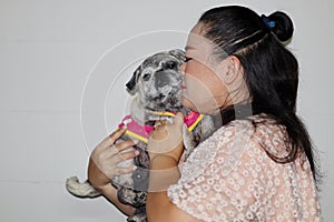 Portrait of an Asian woman, her cute old and fat pug dog group, pet concept.