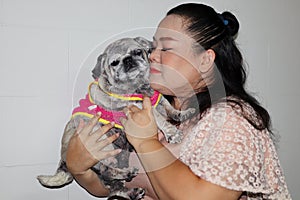 Portrait of an Asian woman, her cute old and fat pug dog group, pet concept.