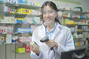 Portrait of asian woman pharmacist wearing lab coat in a modern pharmacy drugstore