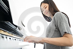 Portrait Asian woman playing  playing piano.