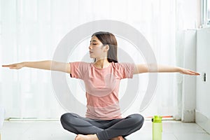 Portrait of asian woman practicing yoga at home