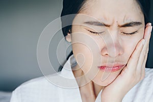 Portrait of Asian woman suffering from toothache.