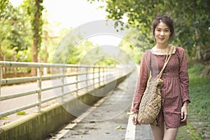 Portrait of asian woman teenage dress in casual walk with big smile on outdoor public park ,liftstyle teenage in new genaration