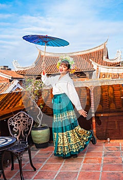 Portrait of asian woman wearing a floral crown and an ancient horse faced skirt