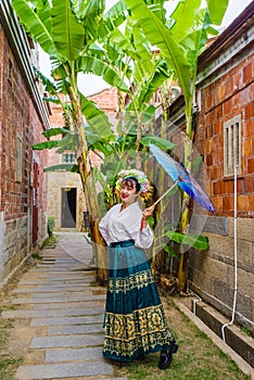 Portrait of asian woman wearing a floral crown and an ancient horse faced skirt