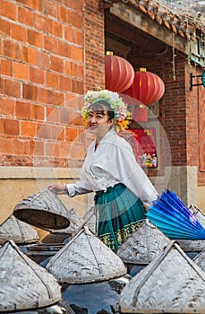 Portrait of asian woman wearing a floral crown and an ancient horse faced skirt