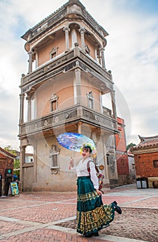 Portrait of asian woman wearing a floral crown and an ancient horse faced skirt