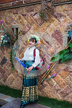 Portrait of asian woman wearing a floral crown and an ancient horse faced skirt