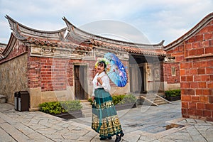 Portrait of asian woman wearing a floral crown and an ancient horse faced skirt